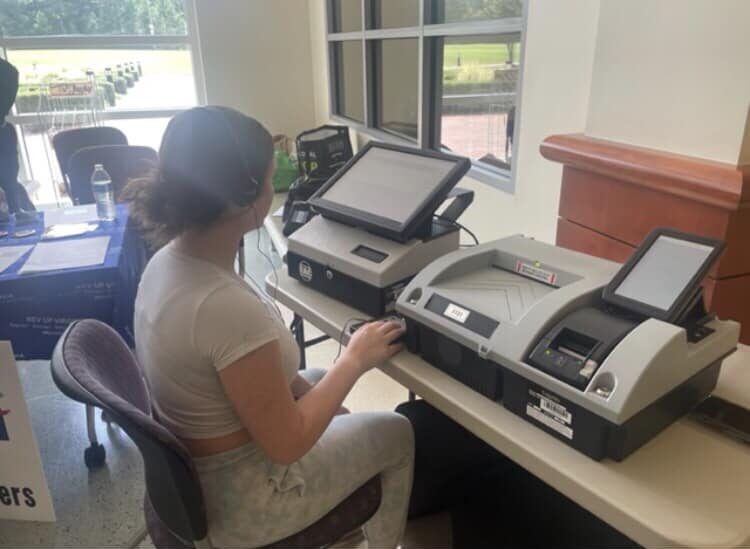 A person uses an accessible voting machine