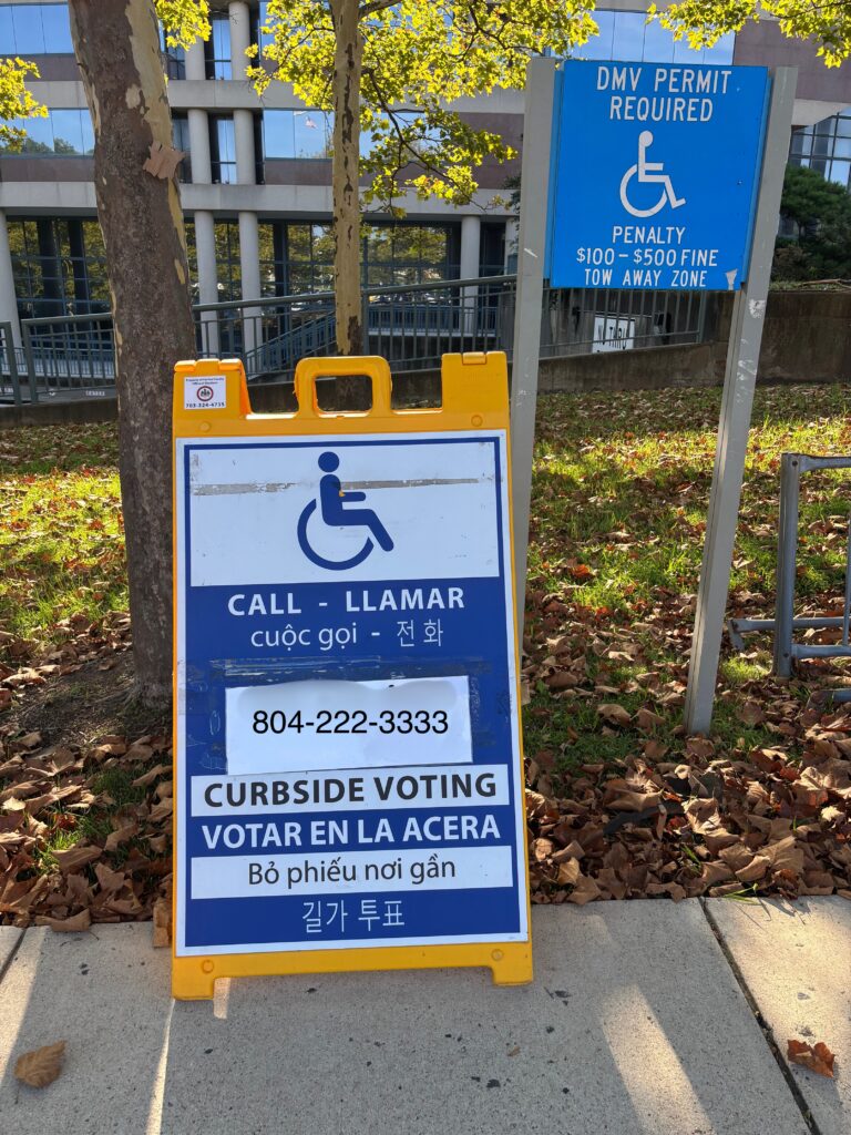 A curbside voting sign with a phone number and the word "CALL" in four languages