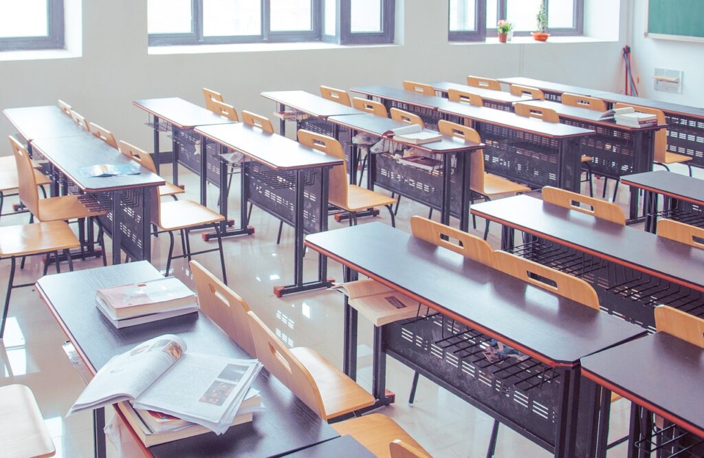 Desks lined up in an empty classroom